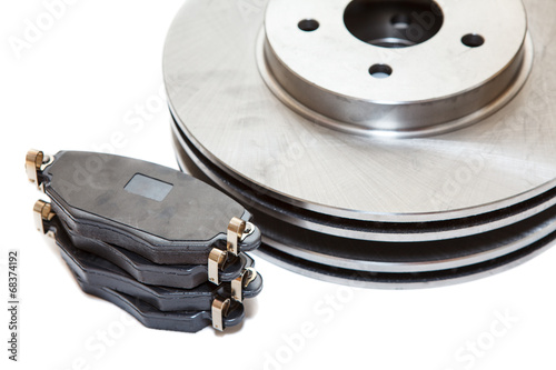Two brake disks and pads isolated on white background