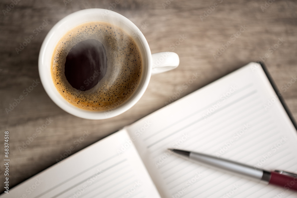 open empty notebook with coffee cup open empty notebook with coffee cup