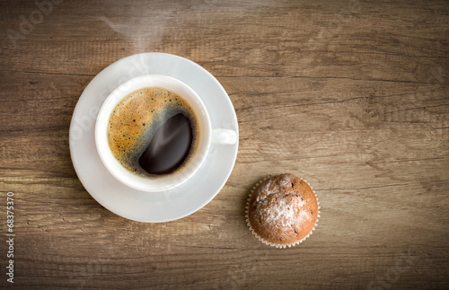 Cup of coffee with cupcake photo