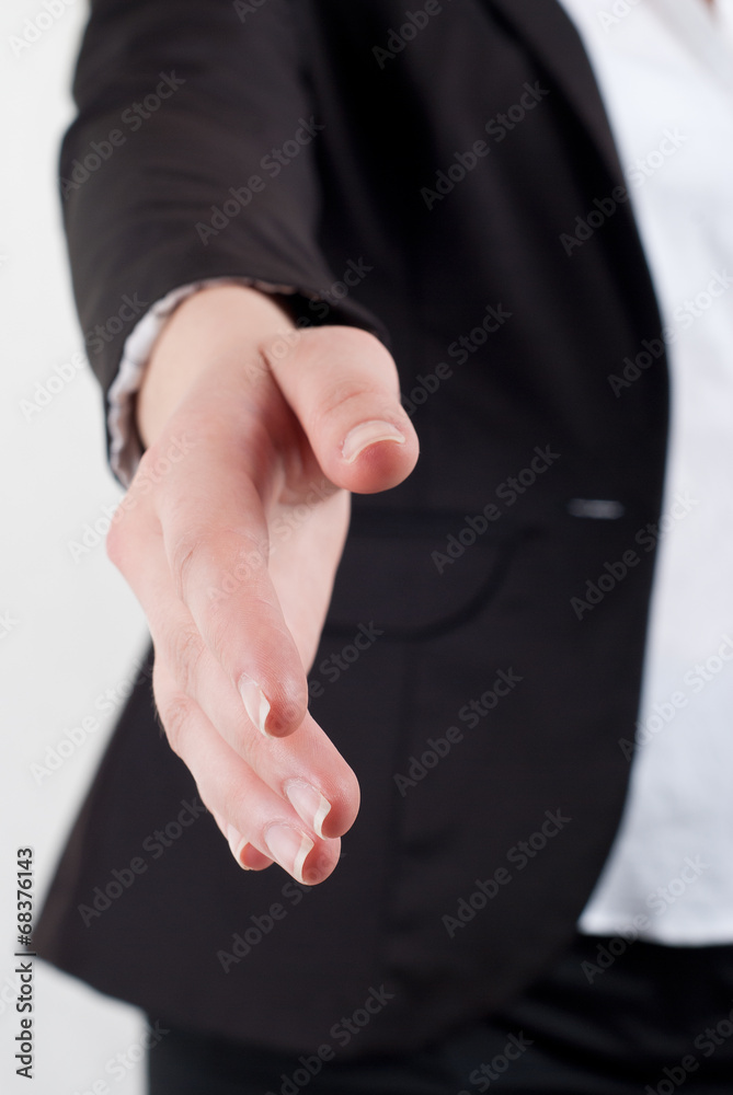 Cropped shot of young bussinesswoman offering a handshake over w