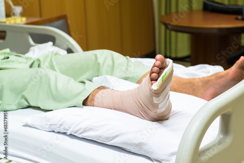 Patient with broken leg in cast and bandage