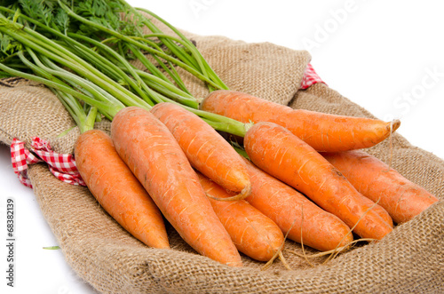 Fresh carrots on a burlap bag
