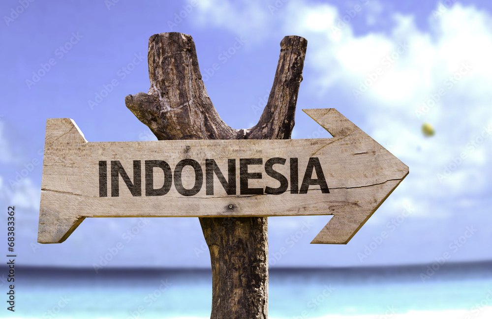 Indonesia wooden sign with a beach on background