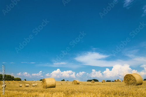 Straw bales against blue sky