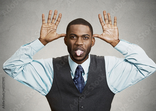 Принти на полотні Executive man mocking someone, sticking his tongue out