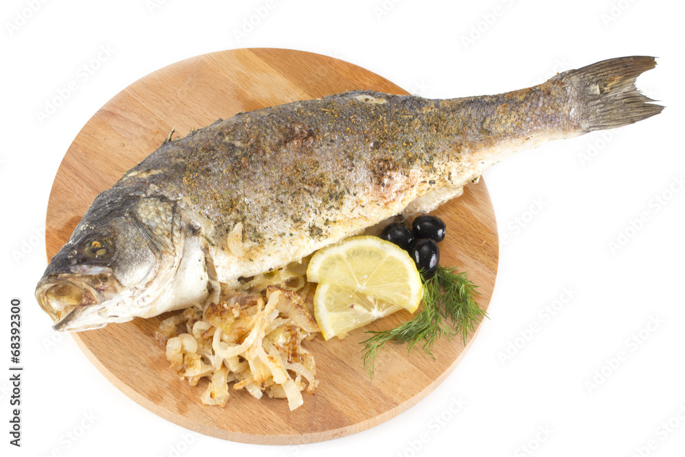 grilled sea bass with lemon, olives, herbs and onions on a woode grilled sea bass with lemon, olives, herbs and onions on a woode