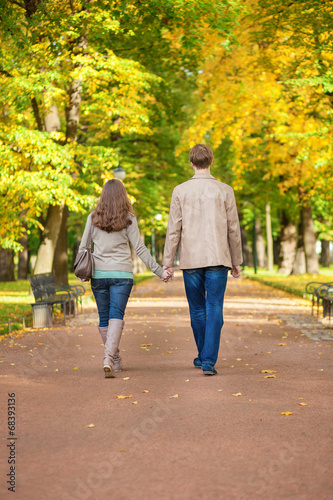 Couple walking together in park on a fall day