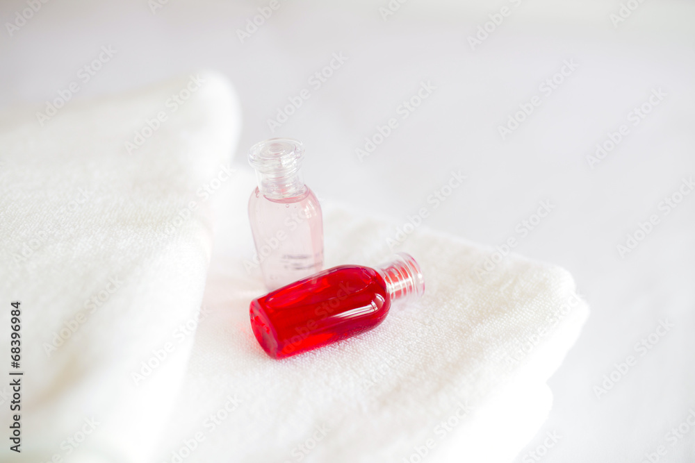 Freshly laundered white fluffy towels with shower gel in bedroom Freshly laundered white fluffy towels with shower gel in bedroom