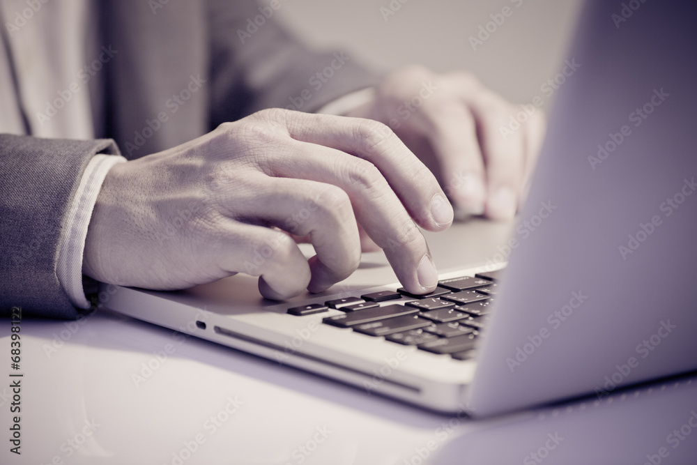 Hands of a man working with laptop Hands of a man working with laptop
