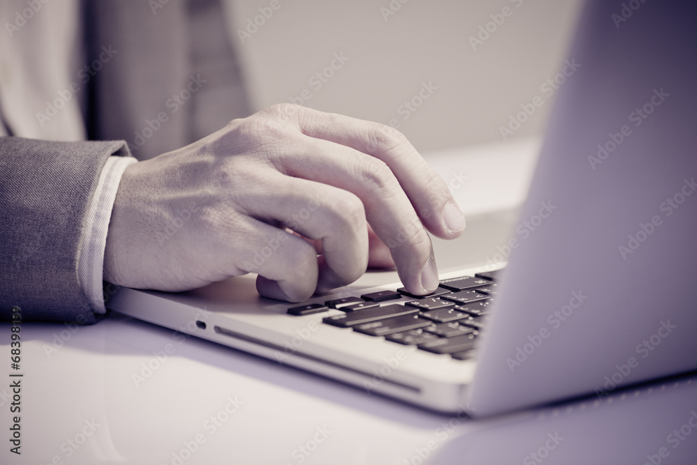 Hands of a man working with laptop Hands of a man working with laptop