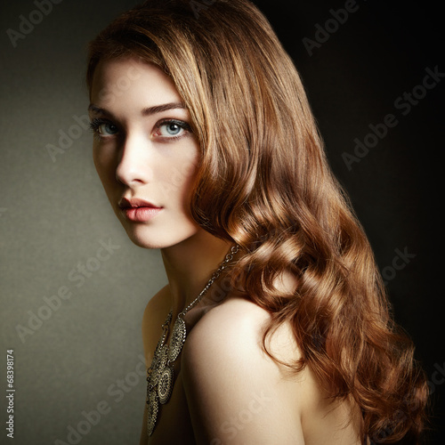 Beauty woman with long curly hair. Beautiful girl with elegant h