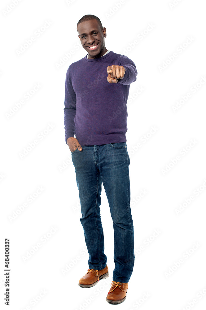 Smiling guy pointing towards camera