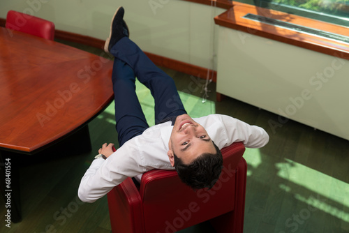 Businessman Relaxing On Office Chair