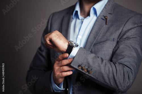 Businessman checking time on his wristwatch © opolja