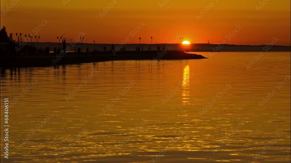 Time lapse of sunset on the lake embankment