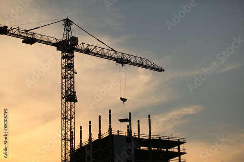 construction crane near the building on sunset background