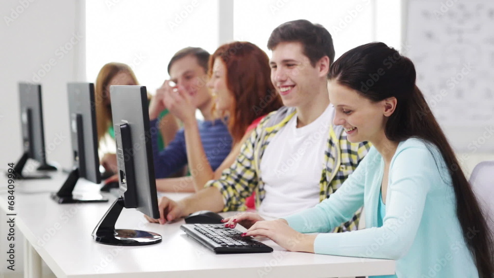 smiling students working with computers at school smiling students working with computers at school