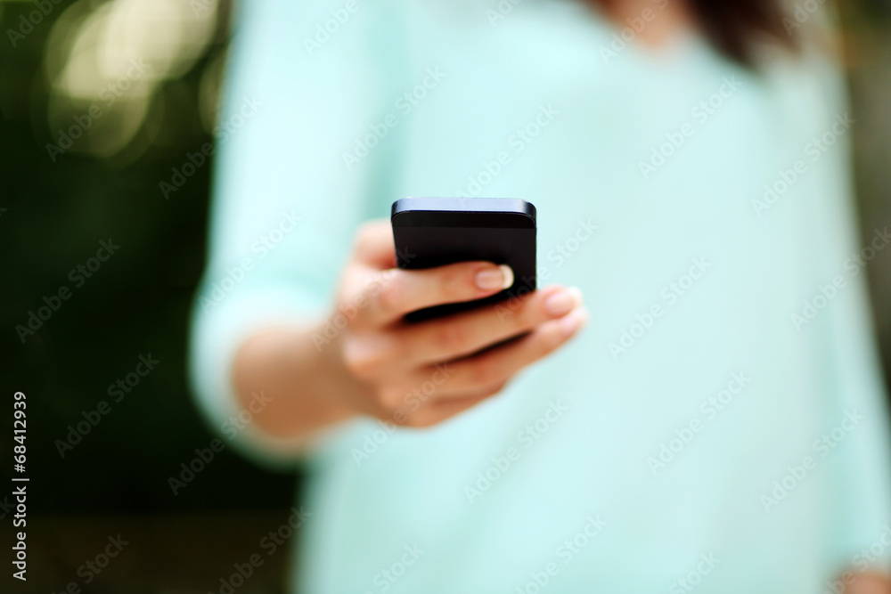 Closeup portrait of a woman using smartphone