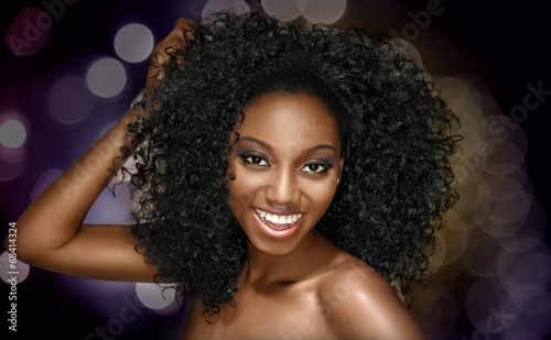 Young woman happy with curly hairstyle on a fun background