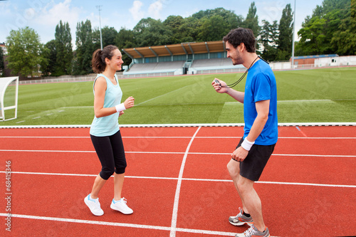 Sport coach training a young attractive woman