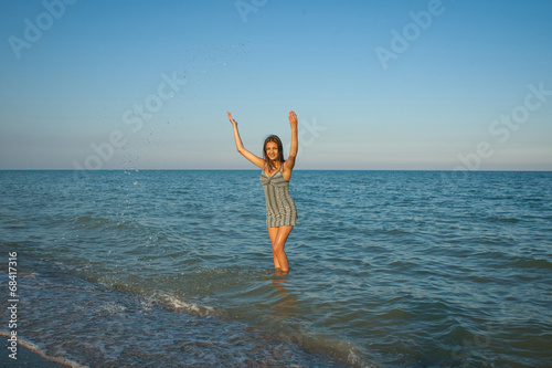 young girl splashing the water in the sea