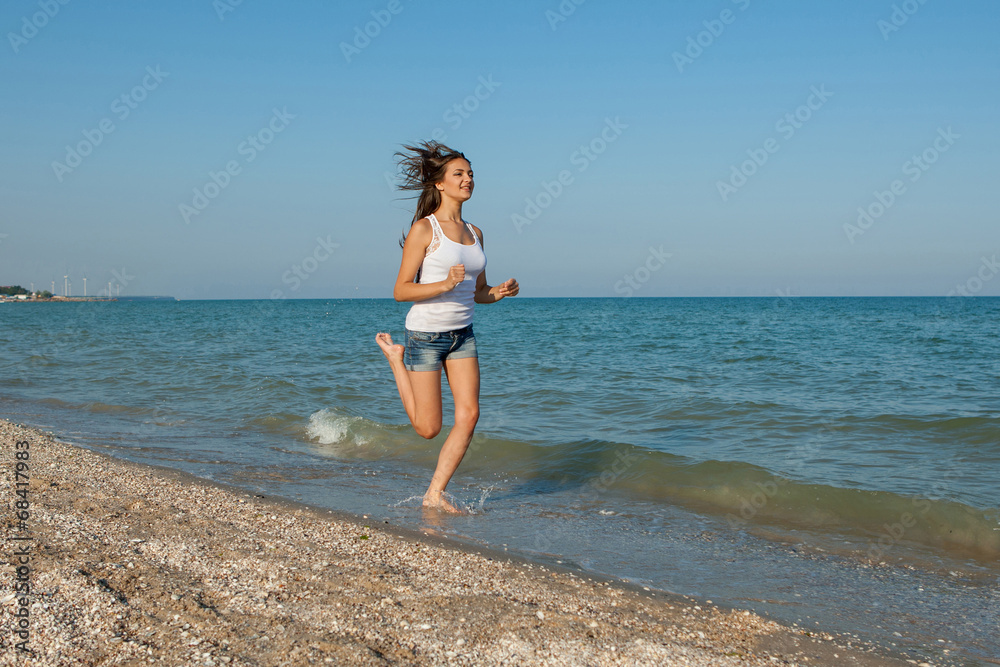 Young girl runs on the sea