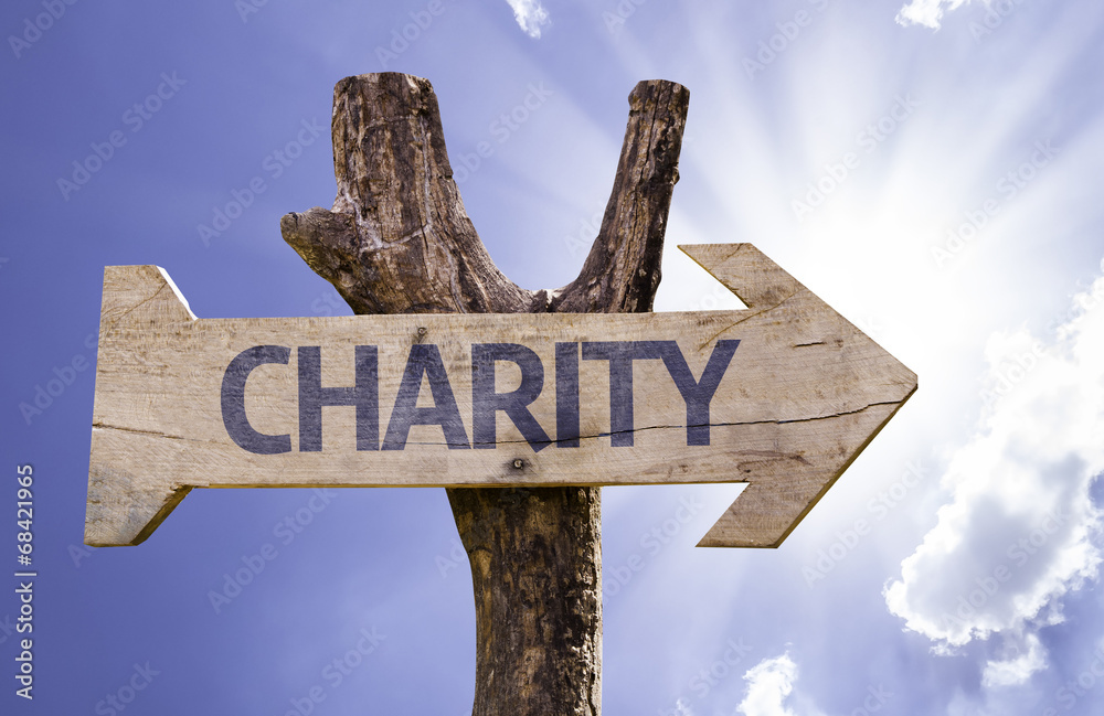 Charity wooden sign on a sky background