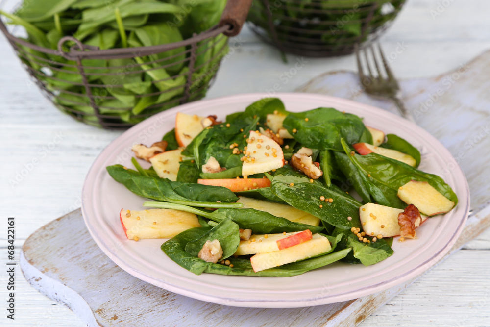 Green salad with apples, walnuts and cheese on wooden Green salad with apples, walnuts and cheese on wooden