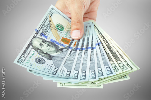 Hand holding money - United States dollar (USD) bills