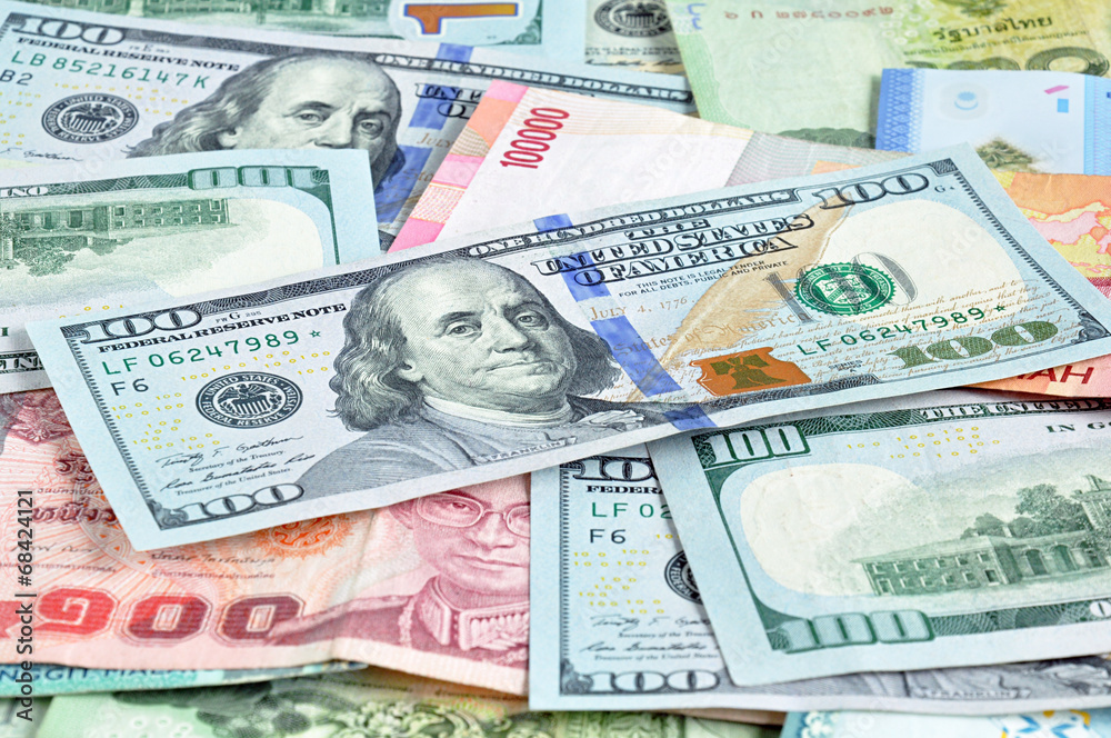 Money in multi currencies with 100 USD bill on top Money in multi currencies with 100 USD bill on top
