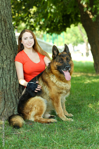 Beautiful young girl with dog in park © Africa Studio