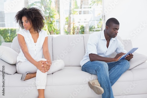 Attractive couple not talking on the couch