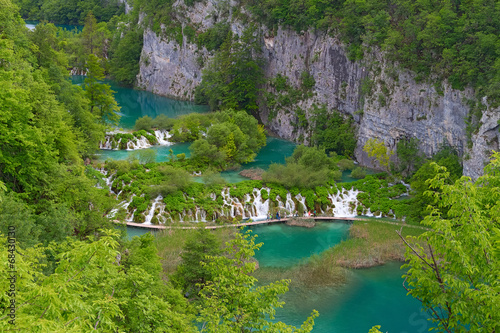 Plitvice lakes  people walking on a footbridge over water