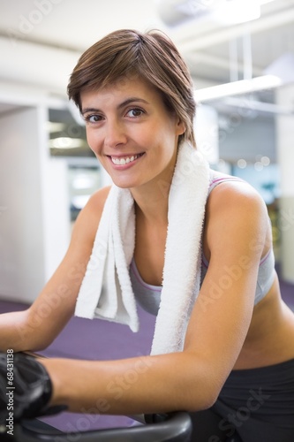 Fit smiling woman working out on the exercise bike Free Download Fit smiling woman working out on the exercise bike - GFXLoad