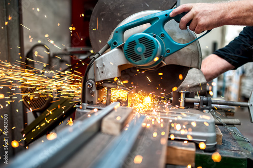industrial worker using a  compound mitre saw