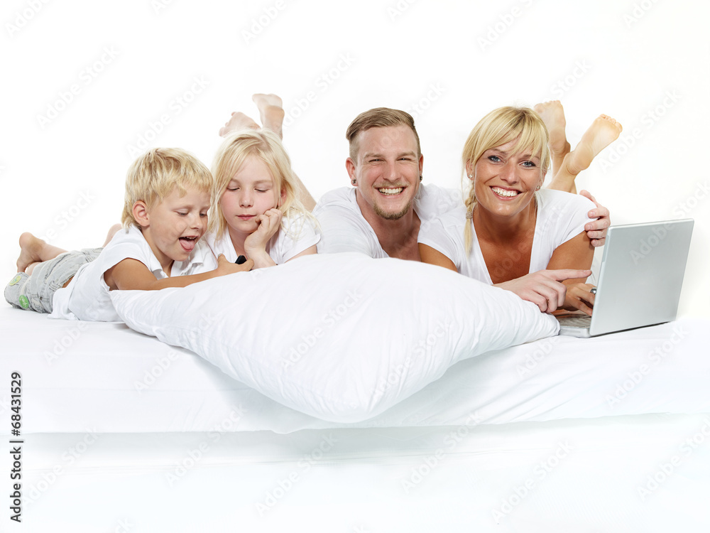 Happy family with laptop stay in bed Happy family with laptop stay in bed