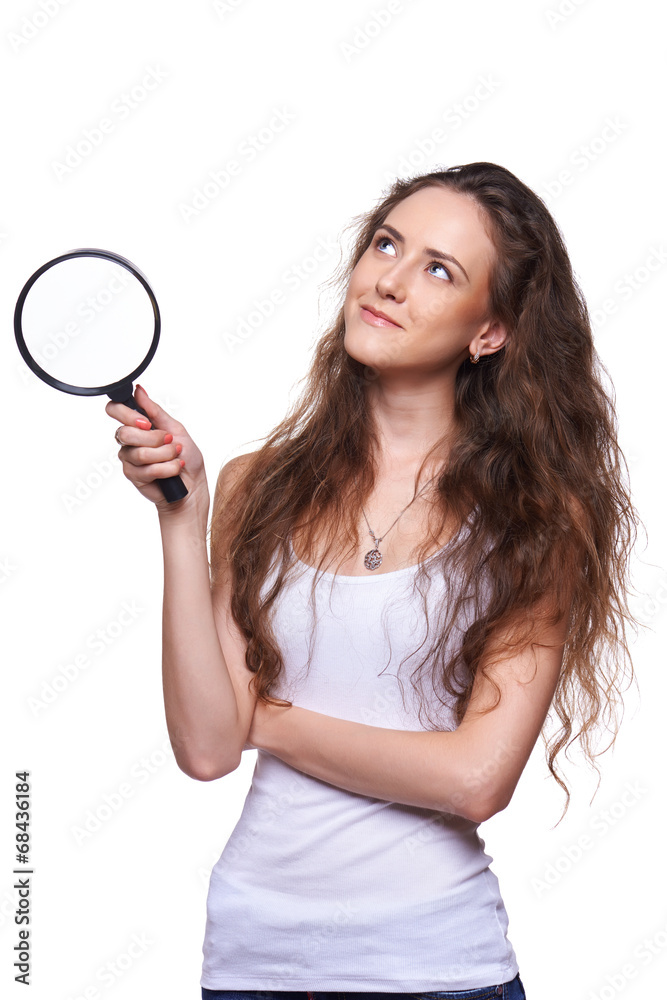 Smiling woman with magnifying glass looking up Smiling woman with magnifying glass looking up