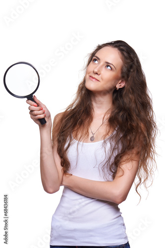 Smiling woman with magnifying glass looking up
