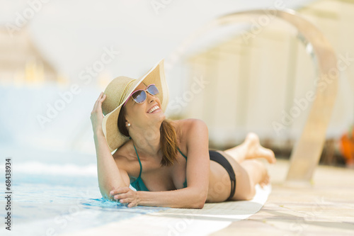 Pretty young woman by the pool