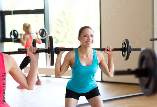 group of women with barbells in gym