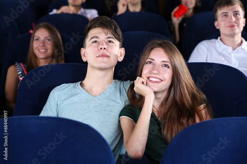 Young couple watching movie...