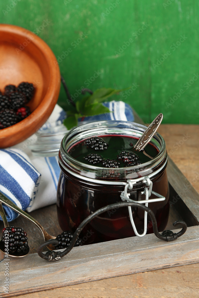 Fototapeta premium Tasty blackberry jam and fresh berries, on wooden table
