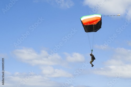 Military parachute in the blue sky.