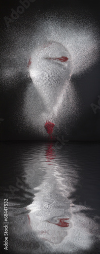 Fototapeta Naklejka Na Ścianę i Meble -  Water balloon exploding reflected on water