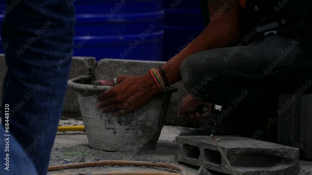 Man Plastering and Layering Wall Bricks. Man Plastering and Layering Wall Bricks.