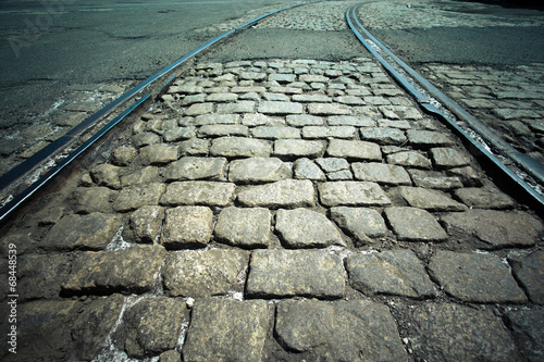 Obraz na plátne Vintage cobblestone street and railroad tracks