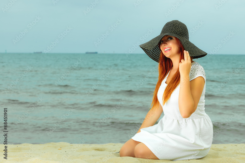 Beautiful redhaired girl in hat on beach, portrait Beautiful redhaired girl in hat on beach, portrait