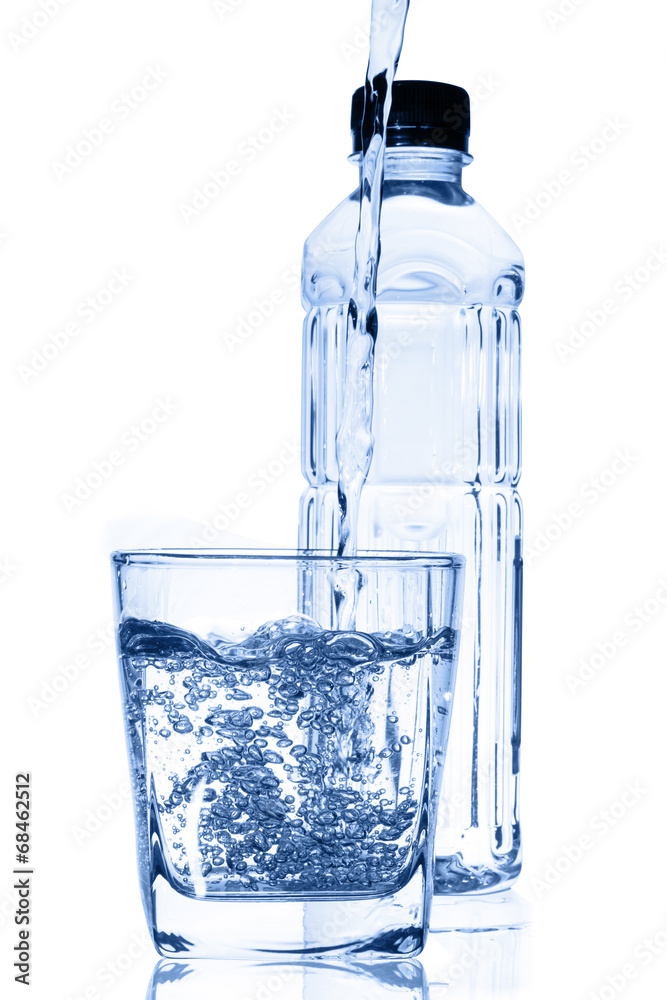 Water pouring into glass with bottle isolated on white. Water pouring into glass with bottle isolated on white.