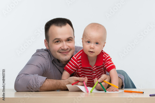 Father and toddler son drawing