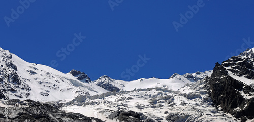 Caucasus mountains under snow and clear blue sky © scullery